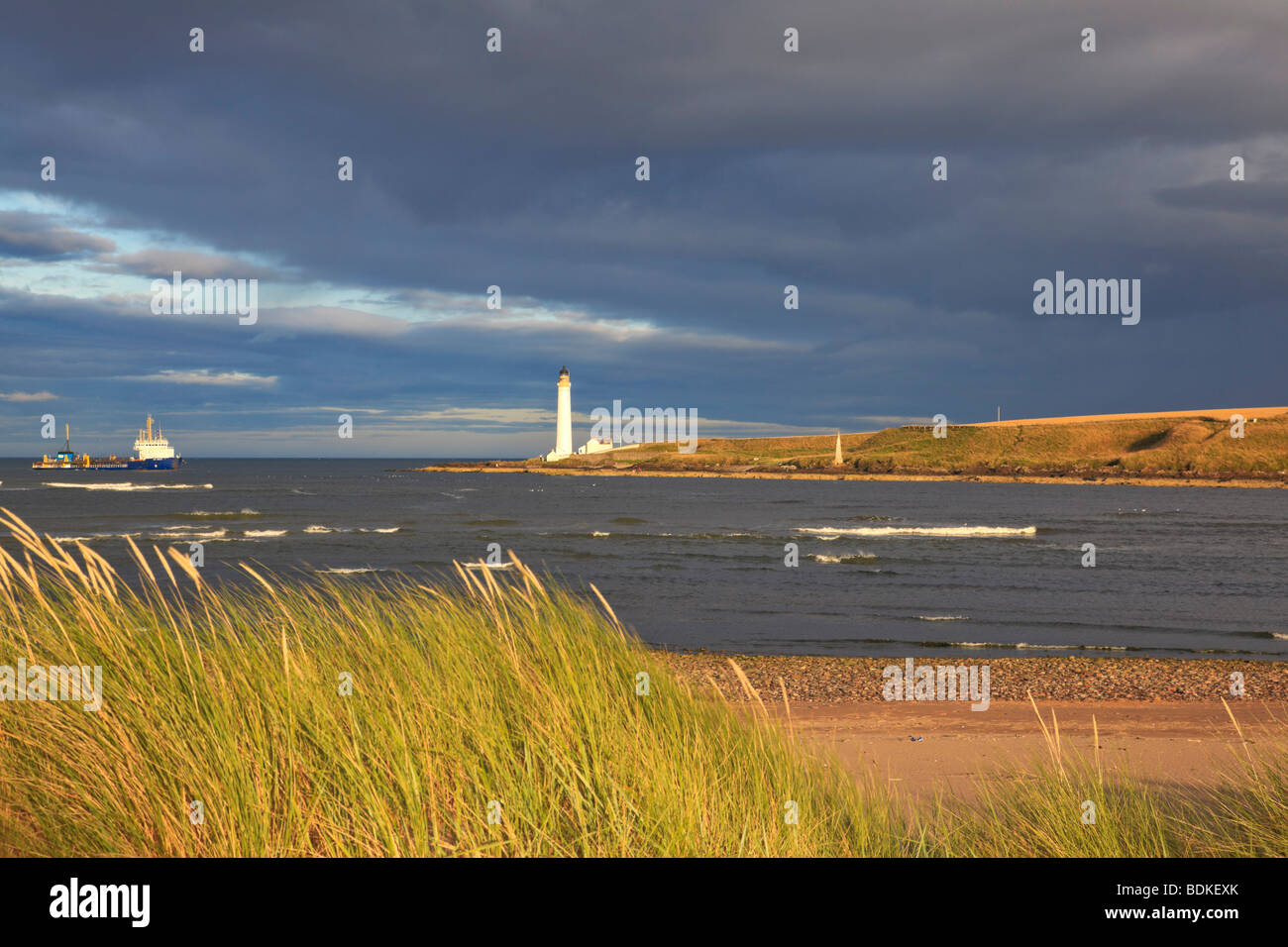 Faro Scurdie Ness con un cielo buio tempestoso, Montrose. Angus, Scozia. Foto Stock