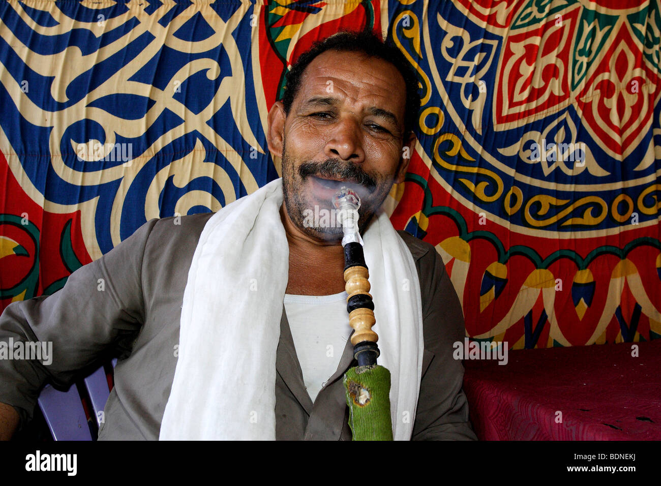 Shisha, uomo di fumare un narghilè, Oasi Bahariya, Sahara egiziano, Egitto, Africa Foto Stock