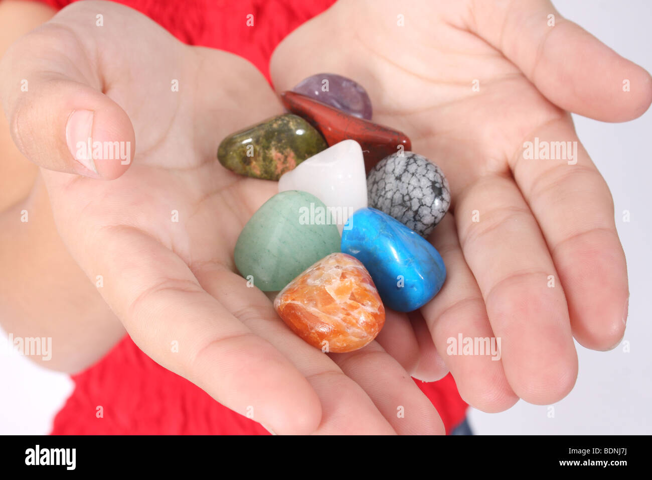 Mani tenendo una selezione di guarigione pietre preziose. Foto Stock