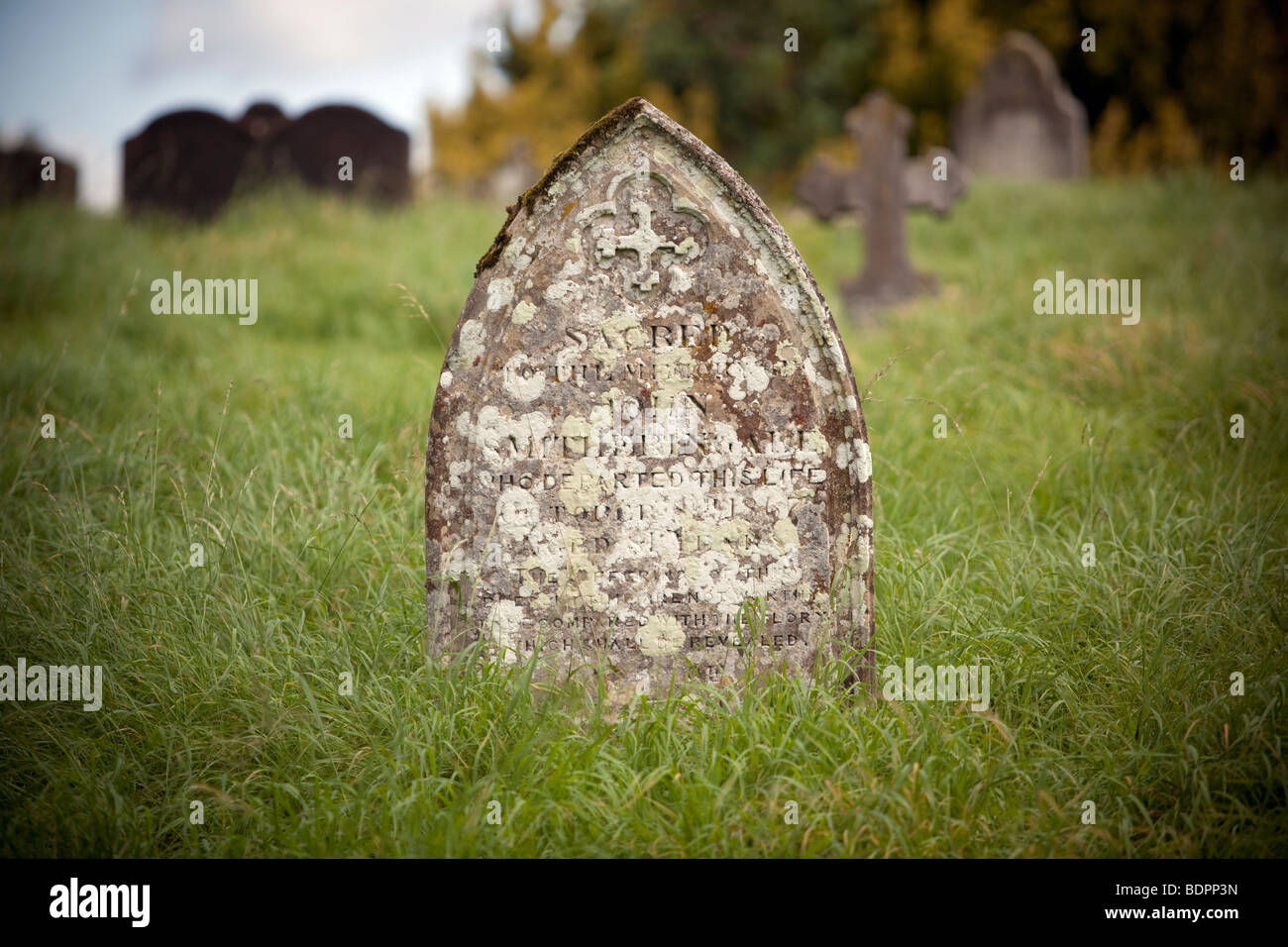 Una tomba in pietra un over cresciuto trascurato nel cortile della chiesa, Worcestershire, Inghilterra, Regno Unito. Foto Stock