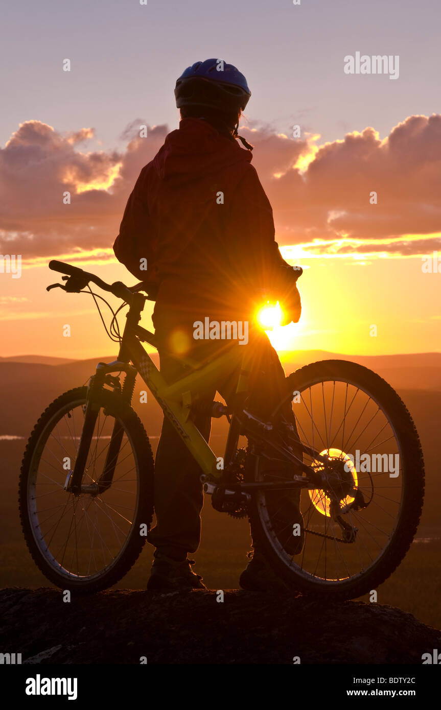 Mountainbikerin in der mitternachtssonne, gaellivare, lappland, SCHWEDEN, downhill ciclista al sole di mezzanotte, Lapponia, Svezia Foto Stock