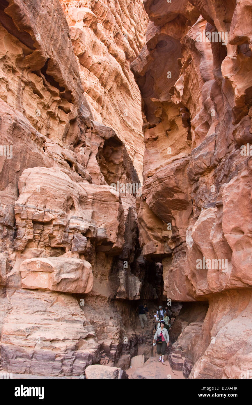 I turisti all'interno Khazali Canyon di Wadi Rum Giordania Foto Stock