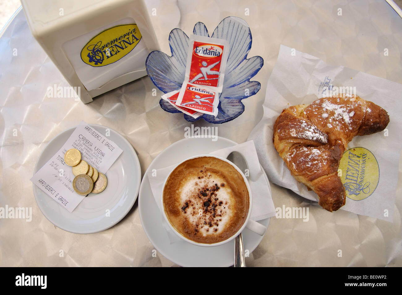 Cappuccino e Cornetto sulla tavola in street cafe, Martina Franca, Taranto Provincia, Regione Puglia, Italia Foto Stock