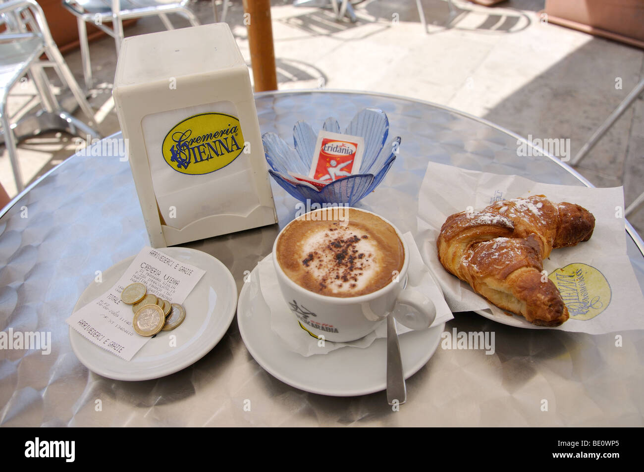 Cappuccino e Cornetto sulla tavola in street cafe, Martina Franca, Taranto Provincia, Regione Puglia, Italia Foto Stock