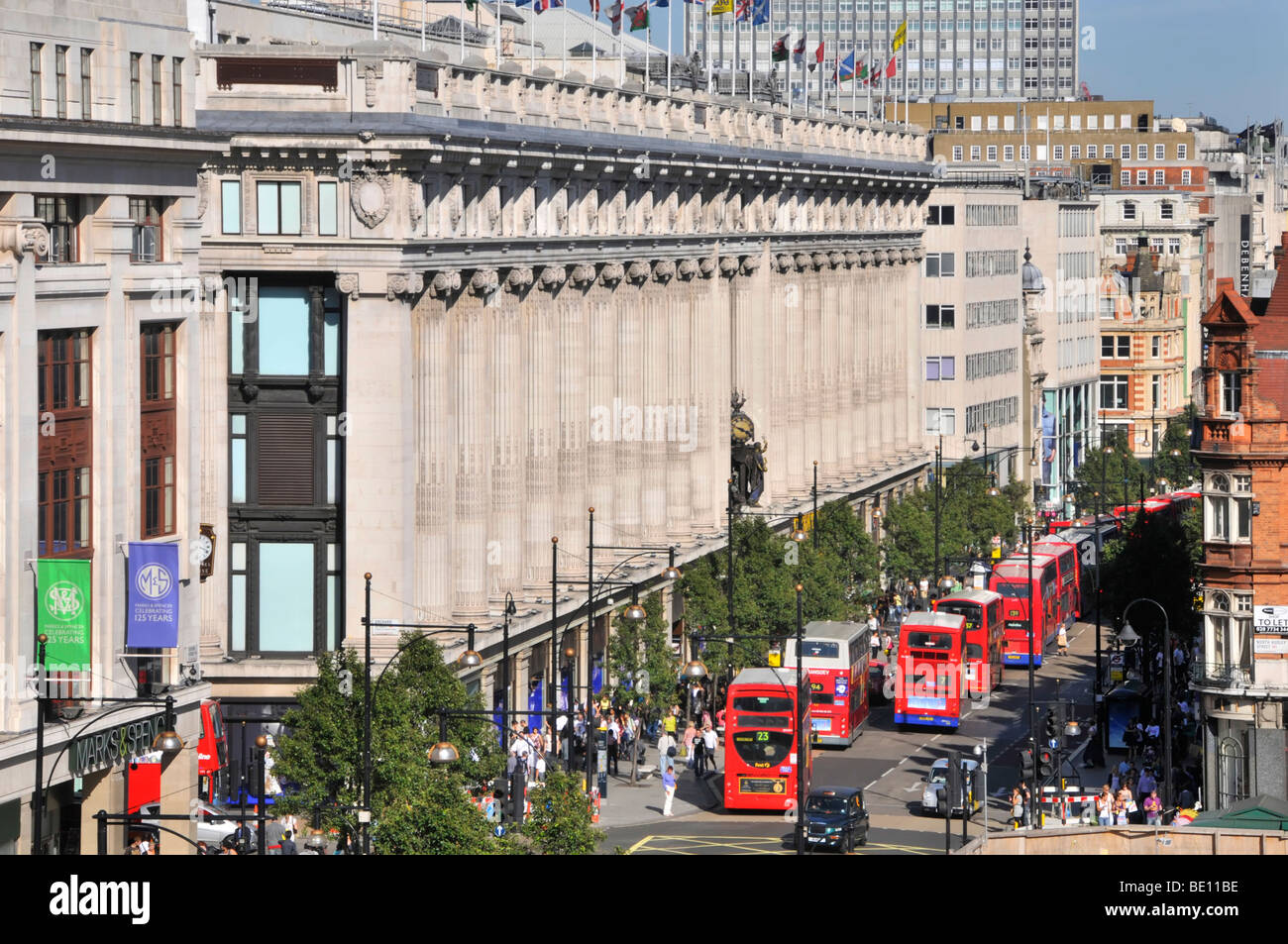 Oxford Street facciata di dal grande magazzino Selfridges con lunga coda di double decker autobus rossi di Londra Foto Stock