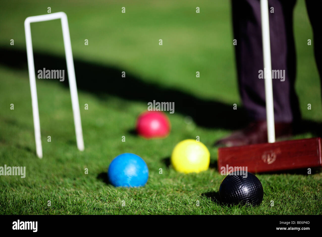 Croquet mallet, sfere e hoop sull'erba Foto Stock