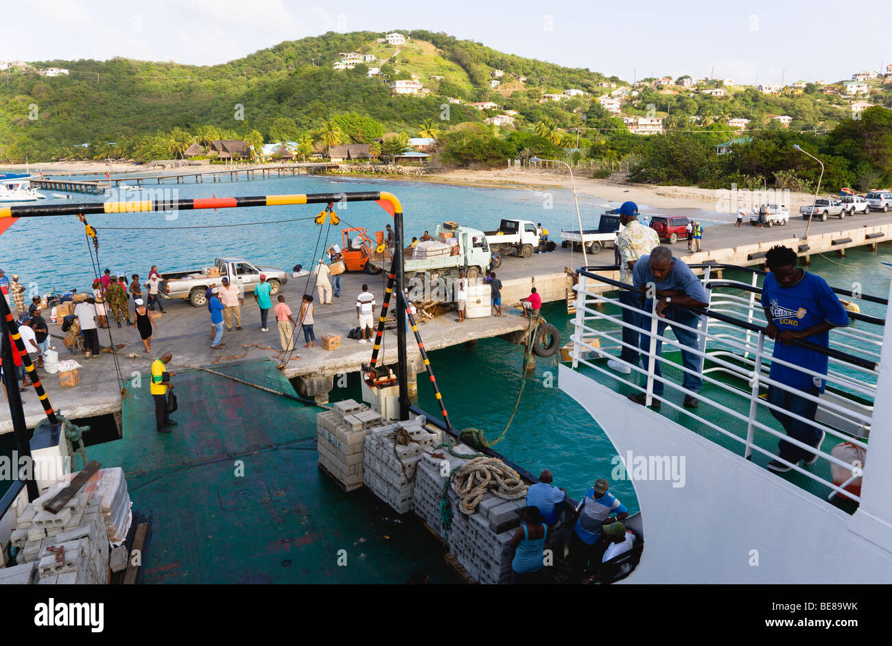 WEST INDIES Caraibi St Vincent e Grenadine Canouan Island Charlestown Bay persone caricamento inter island ferry boat al molo Foto Stock