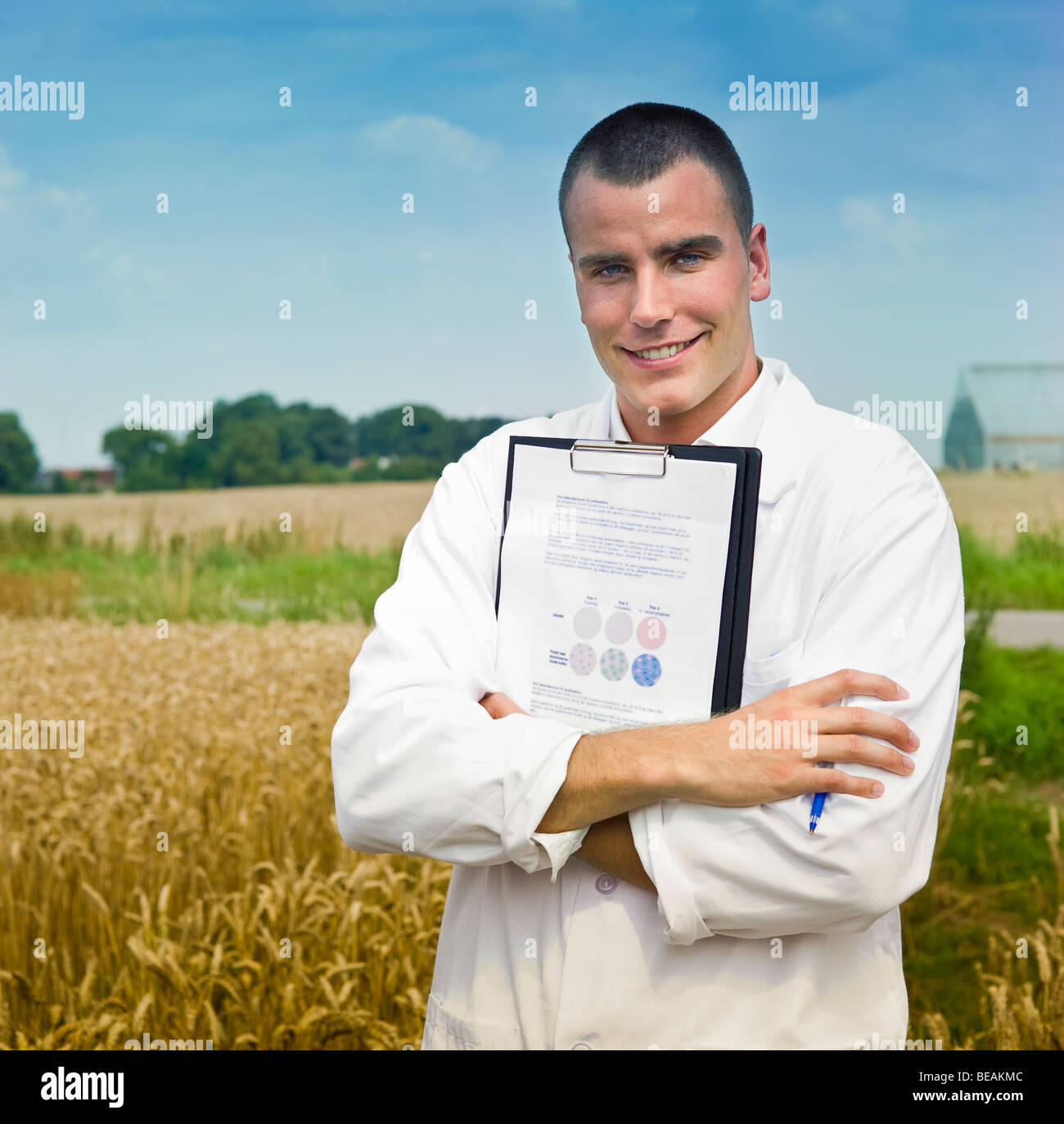 Agricoltura scienziato rendendo note nel campo di serre in background Foto Stock