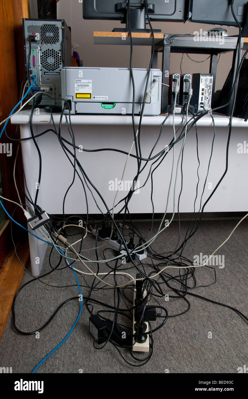 Groviglio di cavi dietro la scrivania del computer Foto stock - Alamy