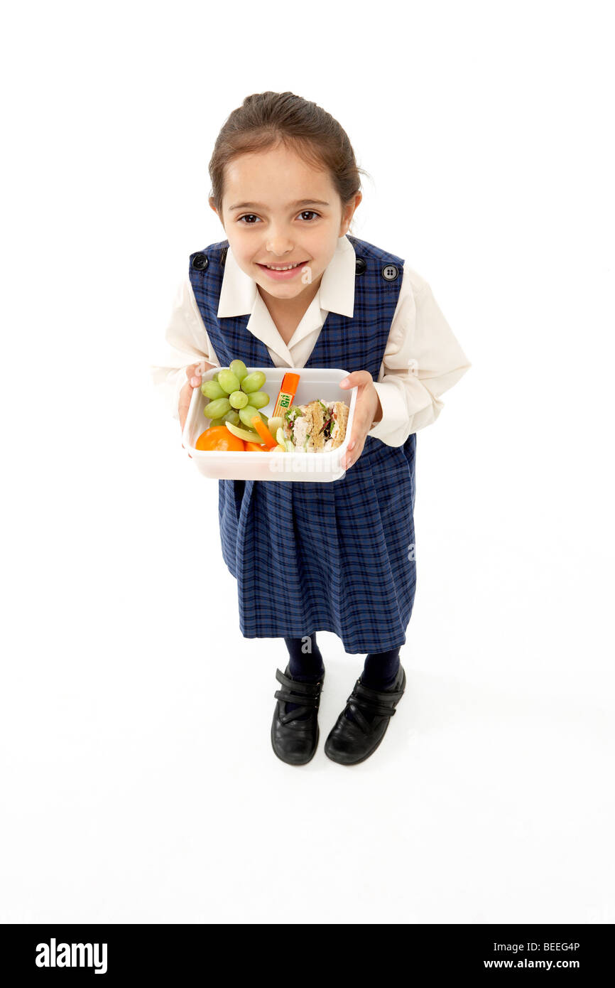 Ritratto in studio della ragazza sorridente Holding Lunchbox Foto Stock