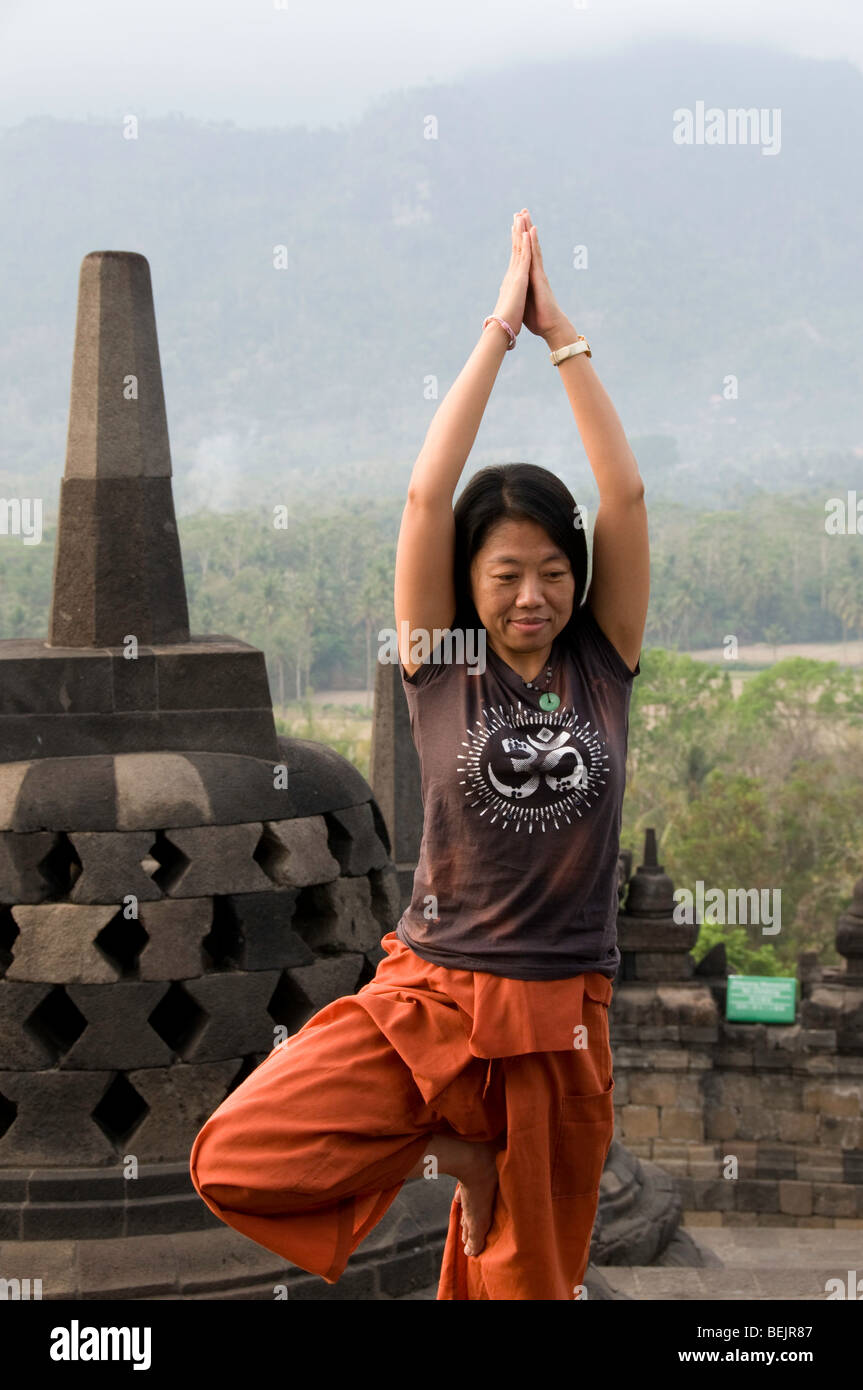La donna a praticare lo yoga al tempio di Borobudur, Java, Indonesia Foto Stock