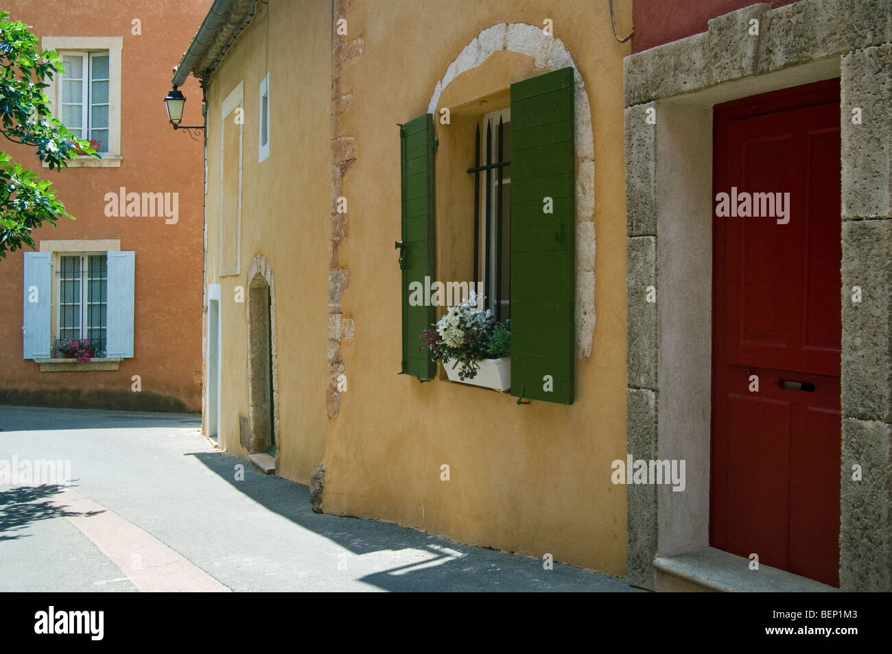 Facciate colorate di case con tendine, Roussillon, Provenza, Vaucluse, Provence-Alpes-Côte d'Azur, in Francia Foto Stock