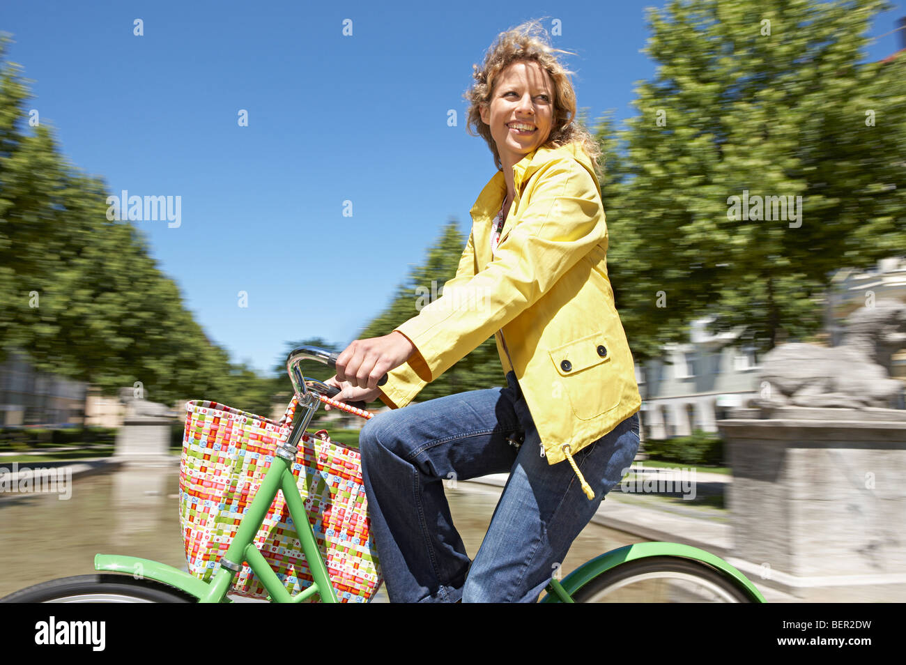 Donna in bicicletta con shopping bag Foto Stock