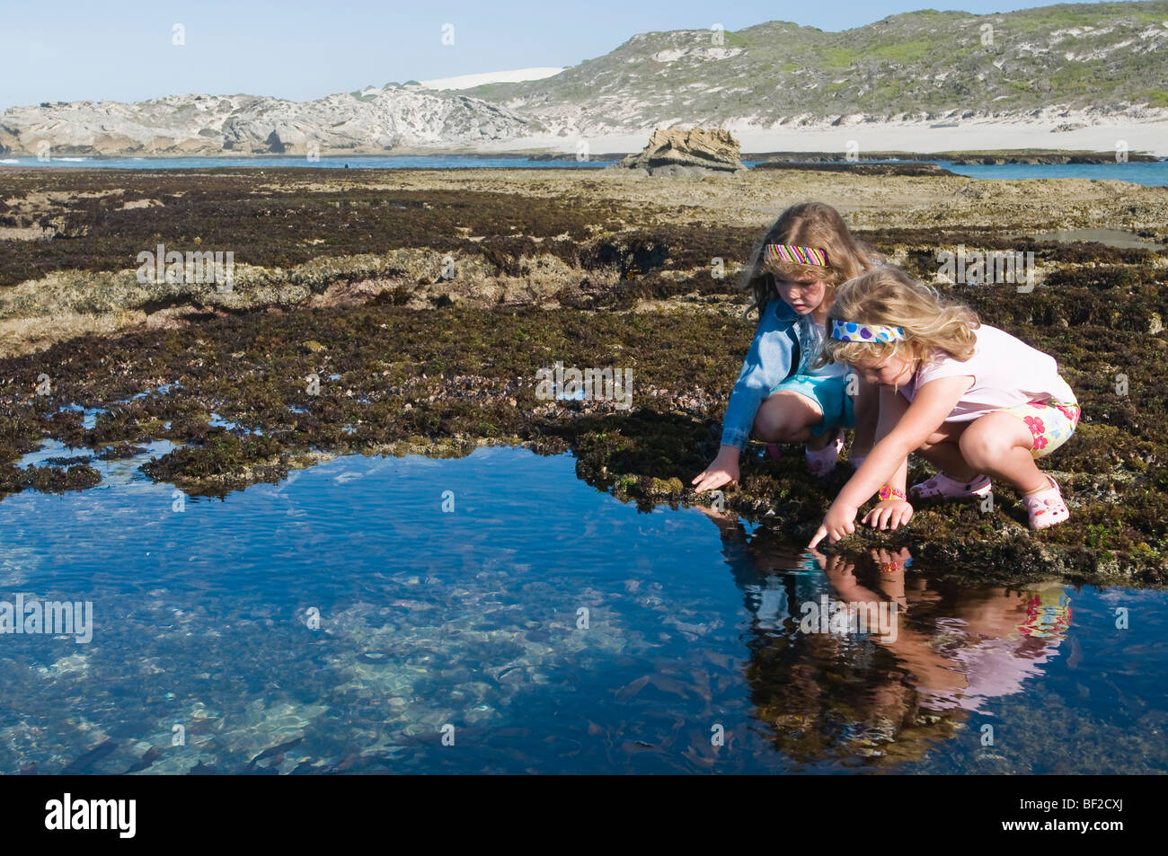 Le ragazze tra maree piscine di roccia, De Hoop Area Marina Protetta, Western Cape, provincia Sud Africa Foto Stock
