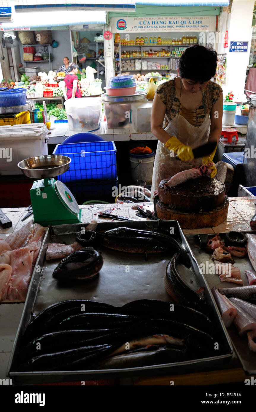 Donna preparare la preparazione di prodotti a base di pesce per la vendita nel mercato aereo aperto di Ho chi minh city Vietnam asia il Mercato Ben Thanh Foto Stock