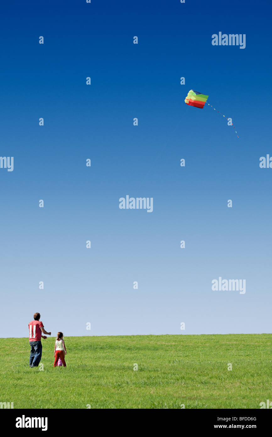 Volare un aquilone padre con i suoi figli Foto Stock