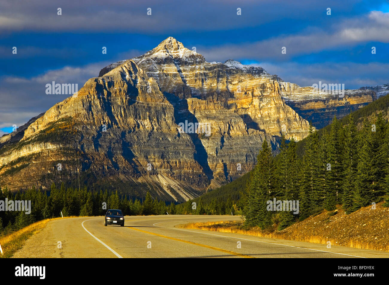 Singola auto sulla strada con Mt. Whymper in background, Kootenay National Park, British Columbia, Canada Foto Stock