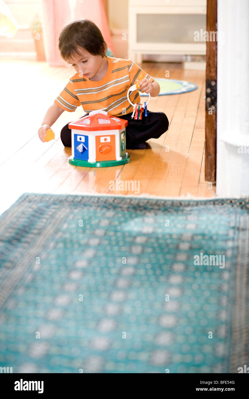 2 1/2 anno vecchio ragazzo giocando sul pavimento con toy, Montreal, Quebec, Canada Foto Stock