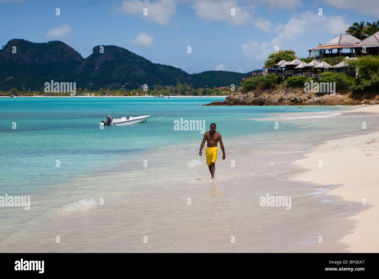 Uomo nero a piedi lungo Ffryes bay, Antigua Foto Stock
