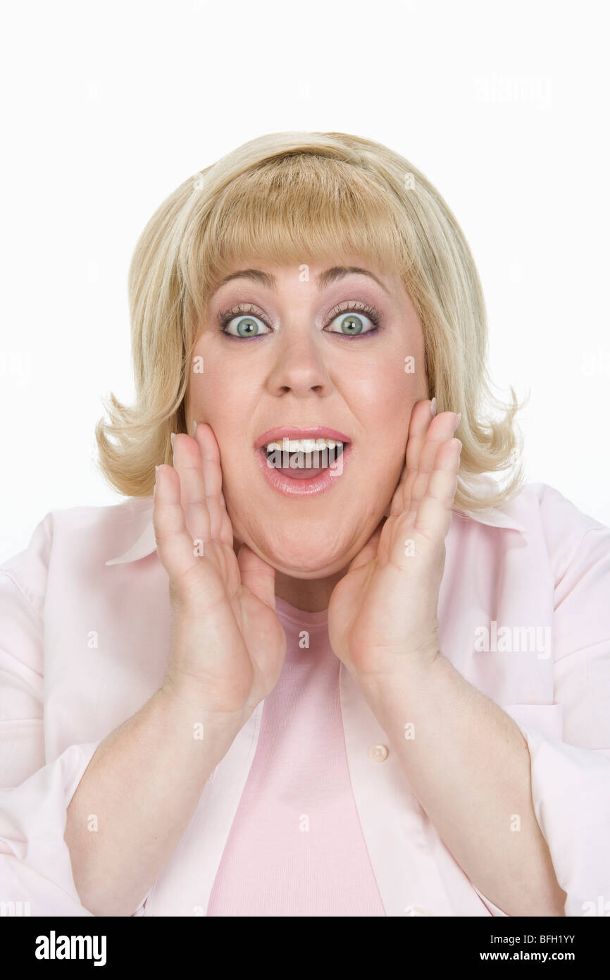 Donna con le mani sul viso Foto Stock