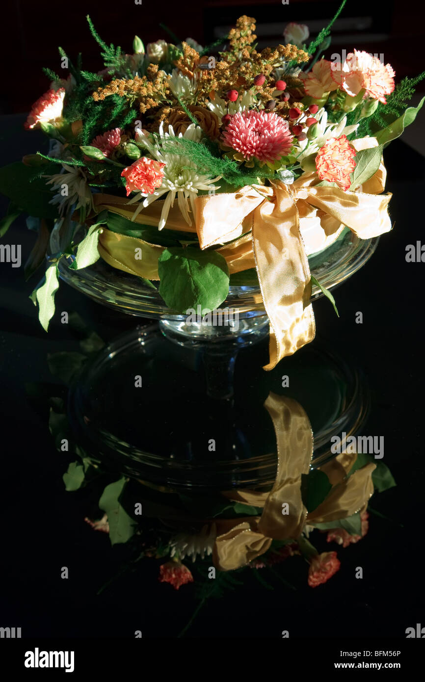 Mazzo di fiori con nastro riflettente su sfondo nero Foto Stock