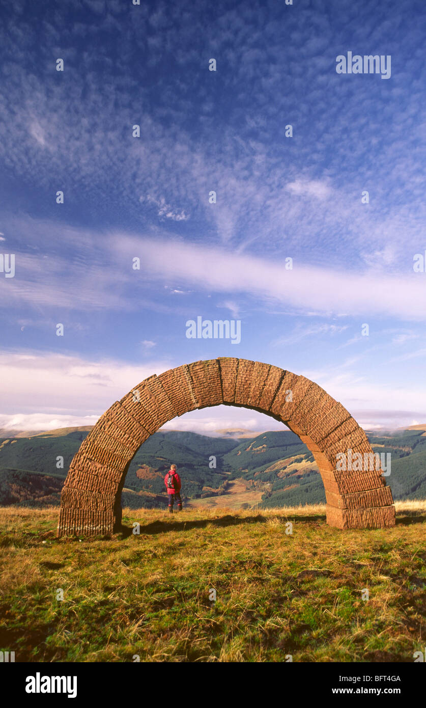 Andy Goldsworhy scultura di estensione degli archi su cauzione Hill walker ammirando il panorama verso il basso glen tutti al di sotto di un big sky Scotland Regno Unito Foto Stock