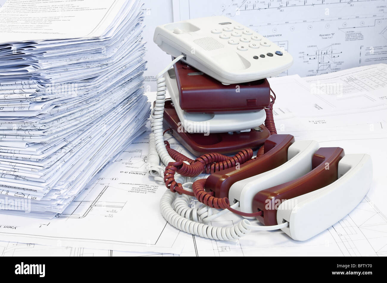 Pile di telefoni a colori e disegni di progetto sul tavolo. Luogo di lavoro Foto Stock