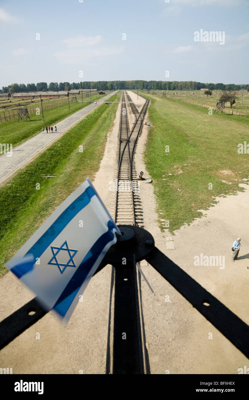 Bandiera israeliana & linee ferroviarie che conducono all'interno da ingresso a Birkenau (Auschwitz II Birkenau) morte nazista camp. Oswiecim, Polonia. Foto Stock