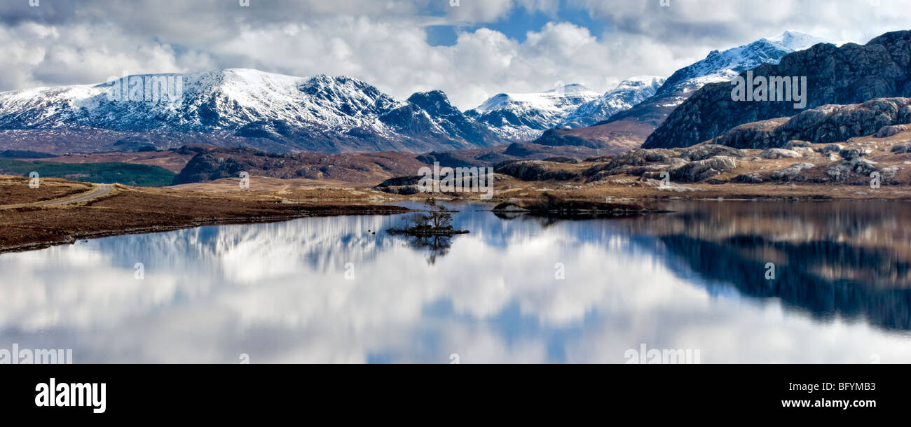 Un inverno montagna innevata scena riflessa in Loch Tollaidh vicino a Poolewe e Gairloch, Wester Ross, Scozia Foto Stock