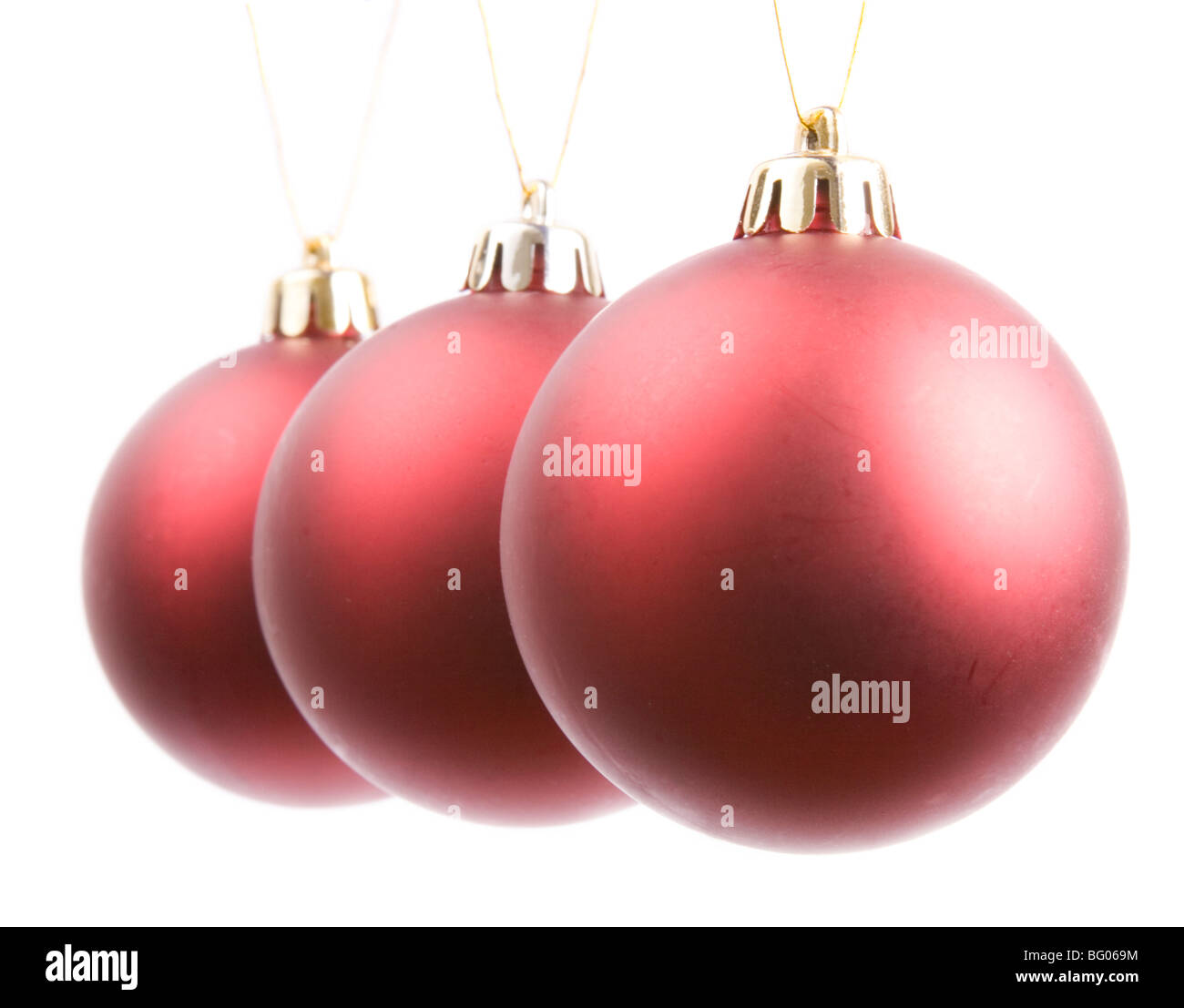 L'essenza di decorazioni di Natale - tre rossi appesi baubles. Foto Stock