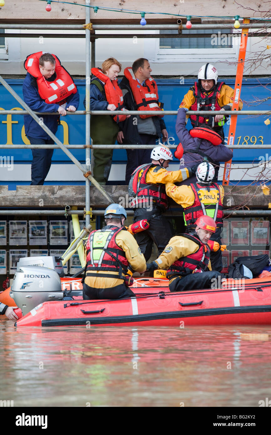 RNLI e mountain rescue team evacuare i residenti da Cockermouths strada principale durante la devastante Novembre 2009 inondazioni. Foto Stock