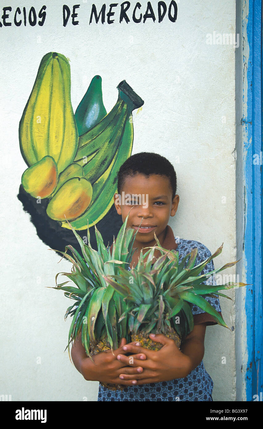 Ragazzo holding ananas al mercato, Repubblica Dominicana, West Indies, America Centrale Foto Stock