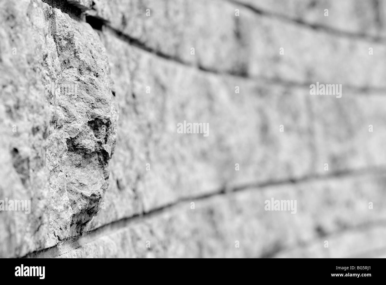 Muro fatto di grezzo dei blocchi di granito. Foto Stock