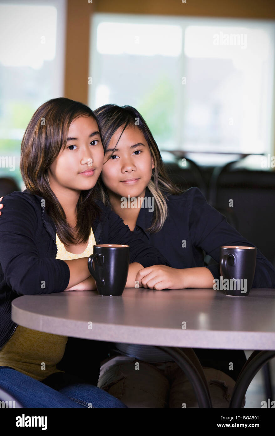 Due ragazze seduti insieme Foto Stock