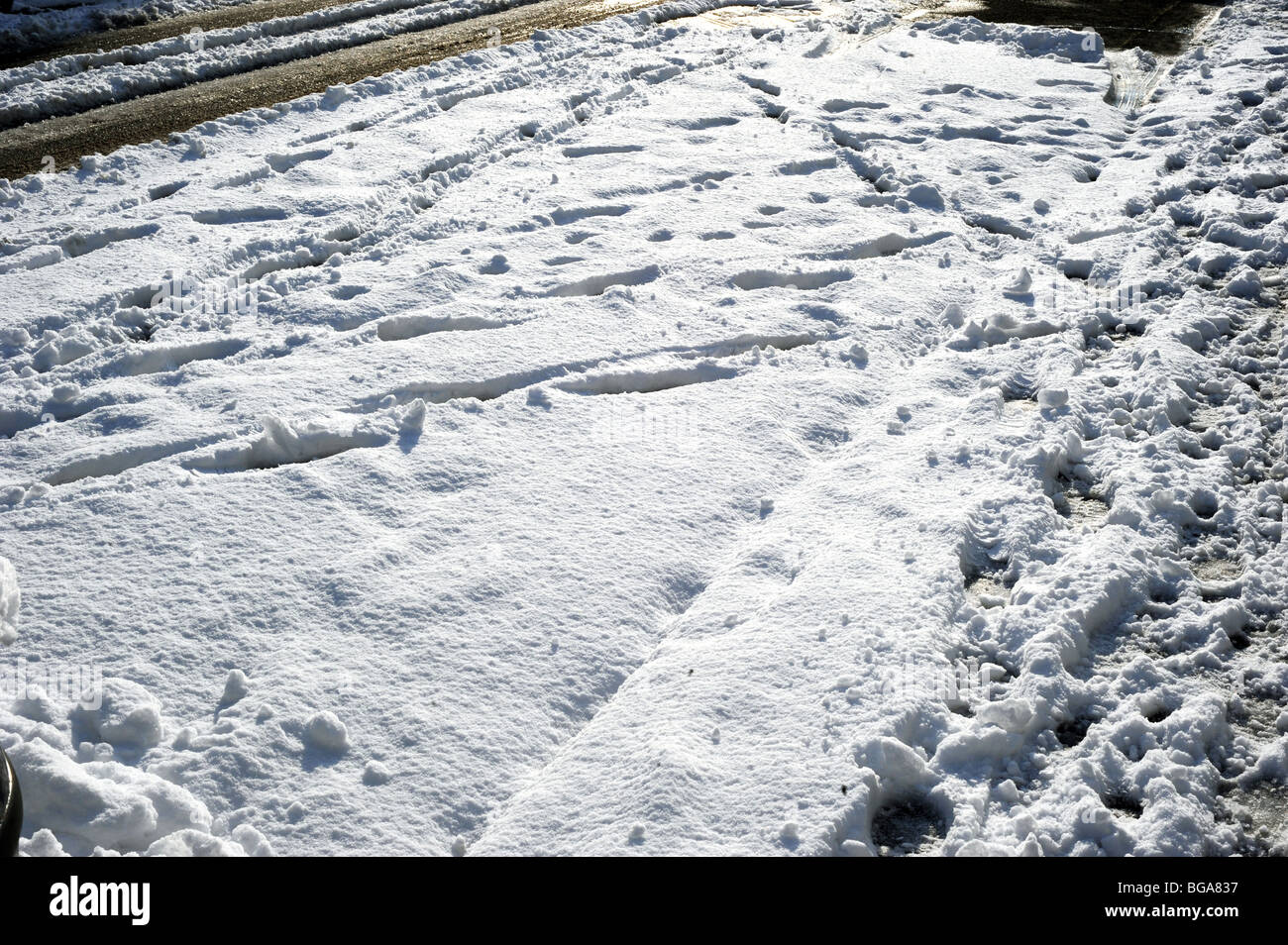 Pneumatici per auto e le orme lasciate sulla neve dopo una pesante caduta in Brighton Foto Stock