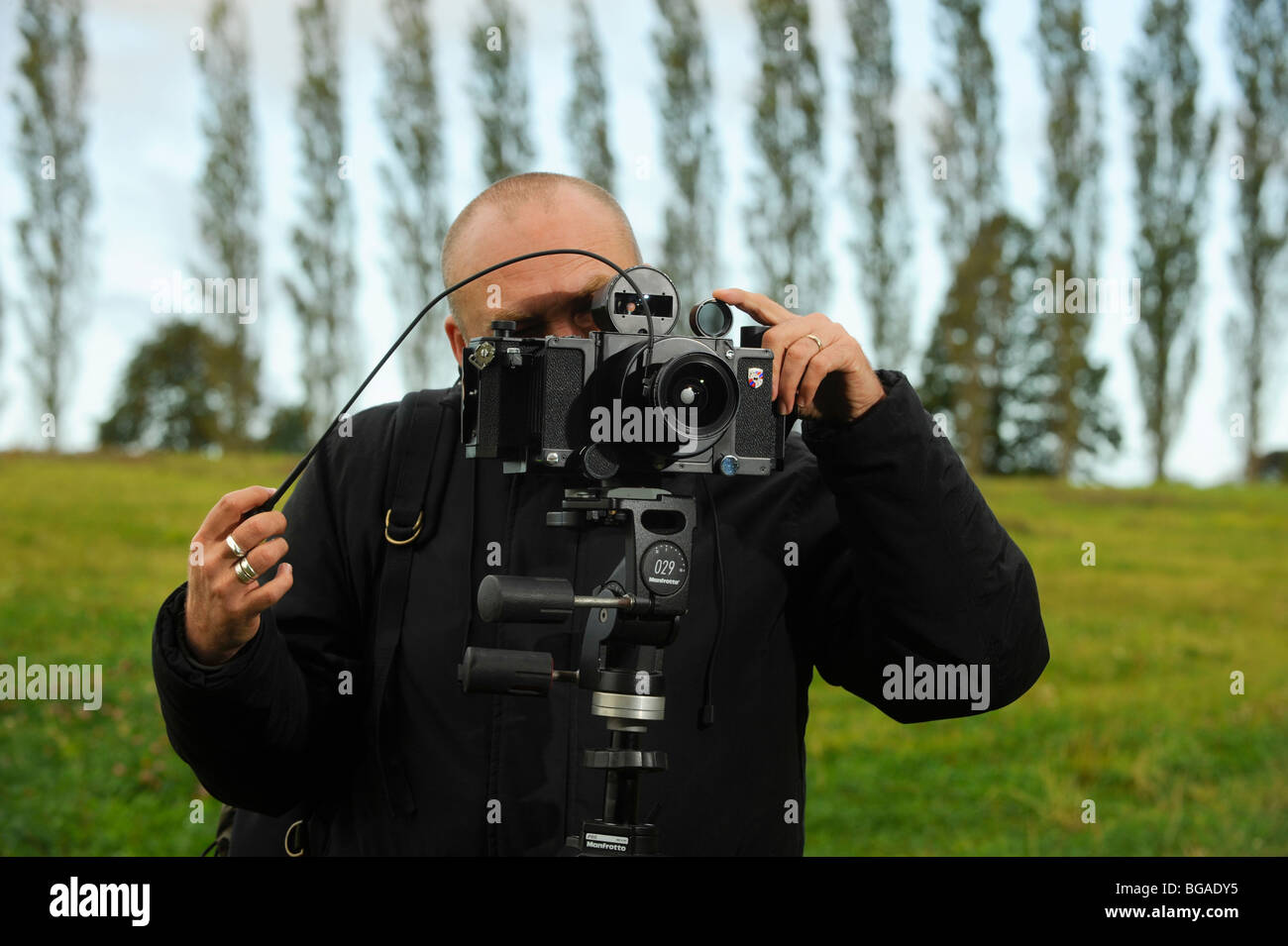 Fotografo di paesaggio Tony Wainwright con una telecamera panoramica 6x17 su treppiede che lavora nei campi del Sussex orientale. Foto Stock