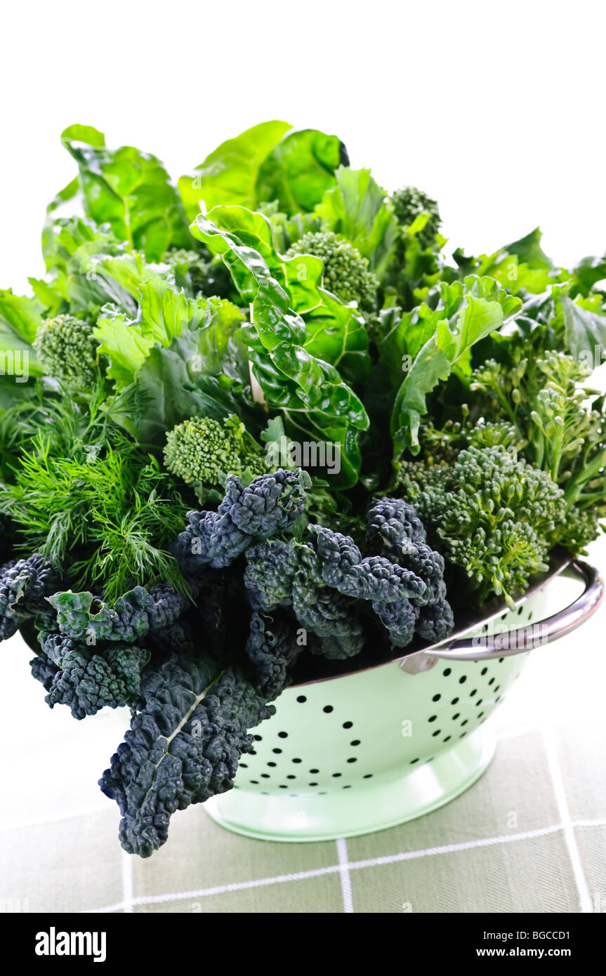 Verde scuro frondosa ortaggi freschi in metallo scolapasta Foto Stock