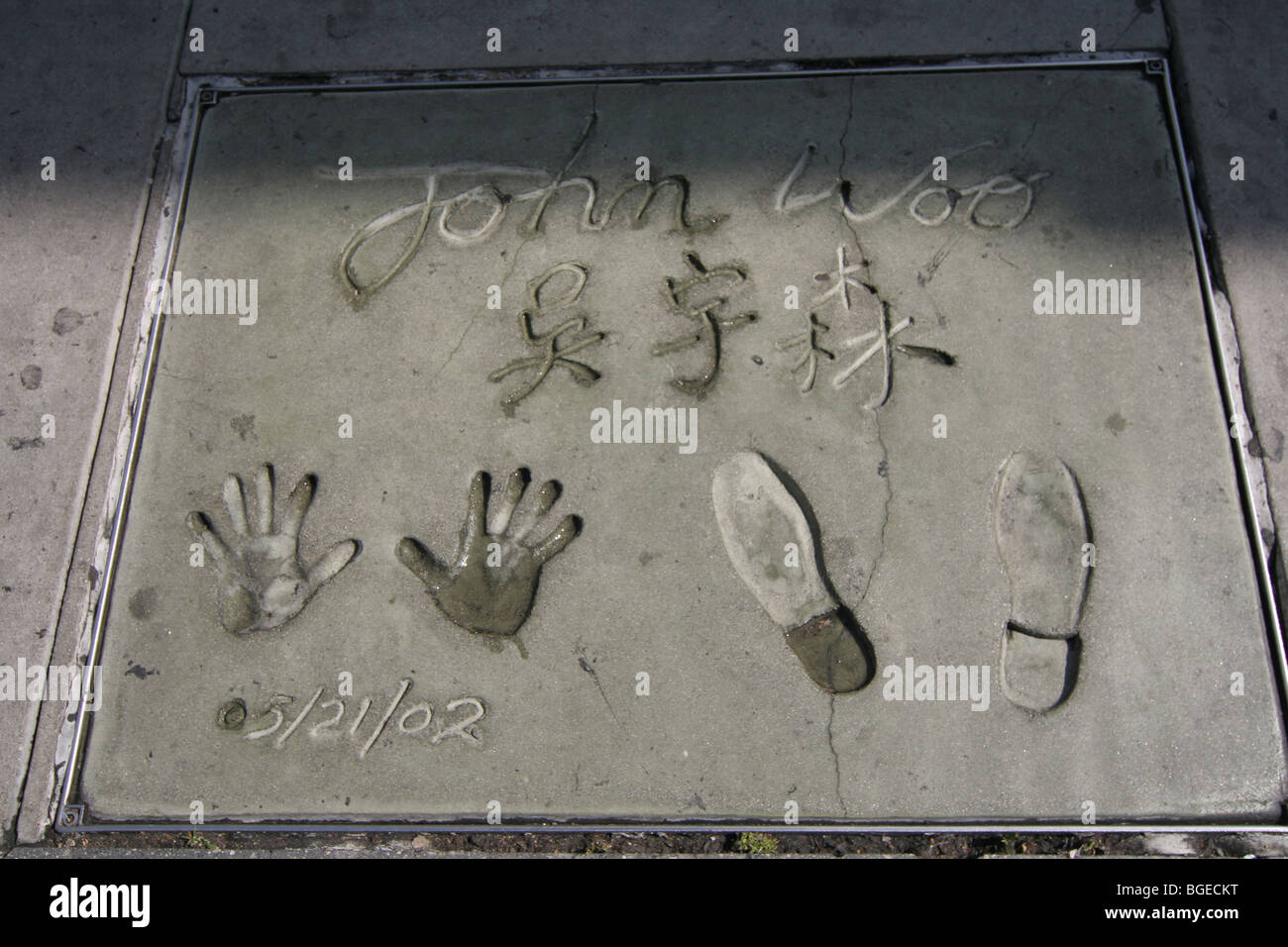 John Woo mani e piedi stampe a camminare di telaio su Hollywood Blvd a Los Angeles Foto Stock