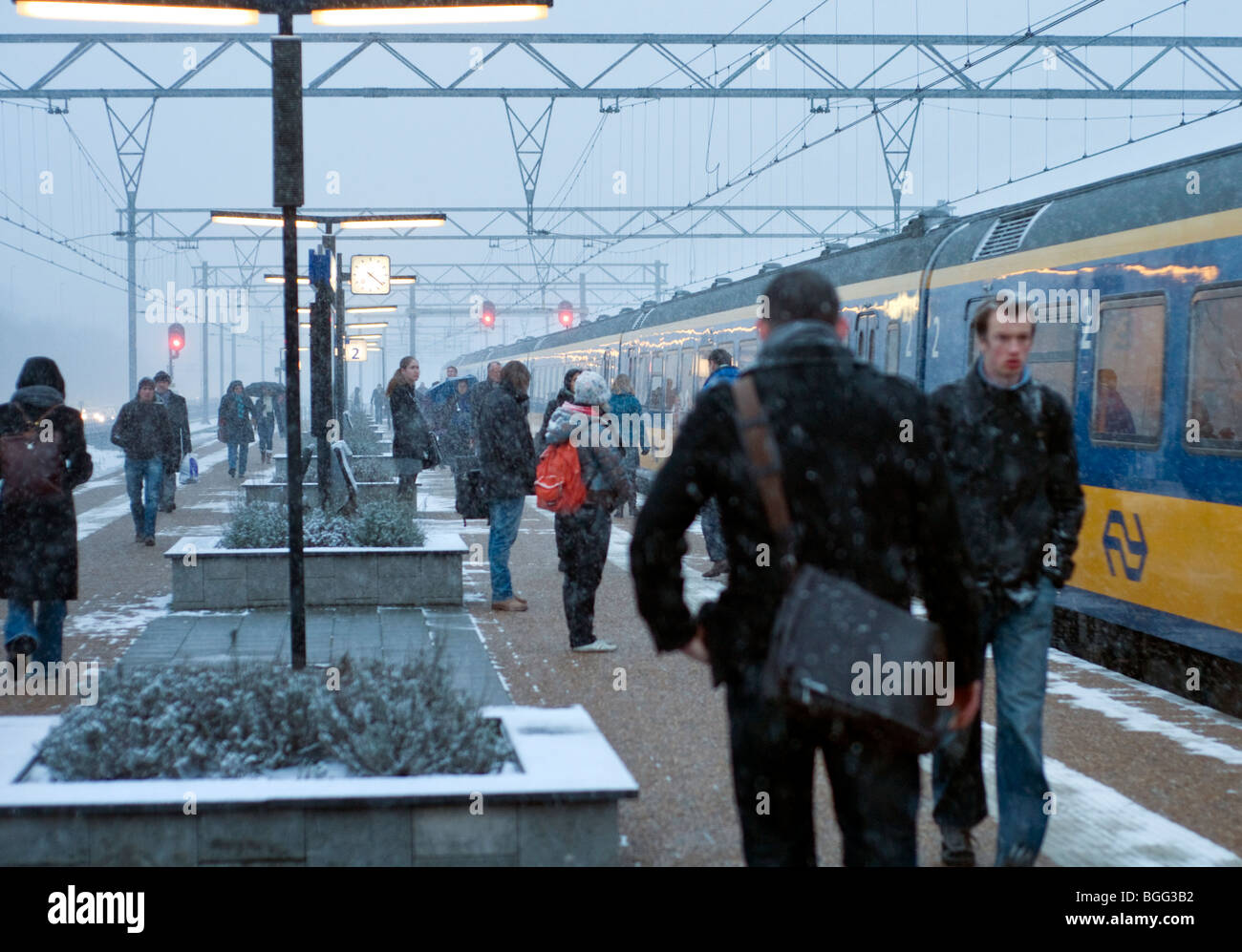 Pendolari battaglia attraverso la neve per prendere un treno a Amsterdam Zuid stazione ferroviaria nei Paesi Bassi Foto Stock