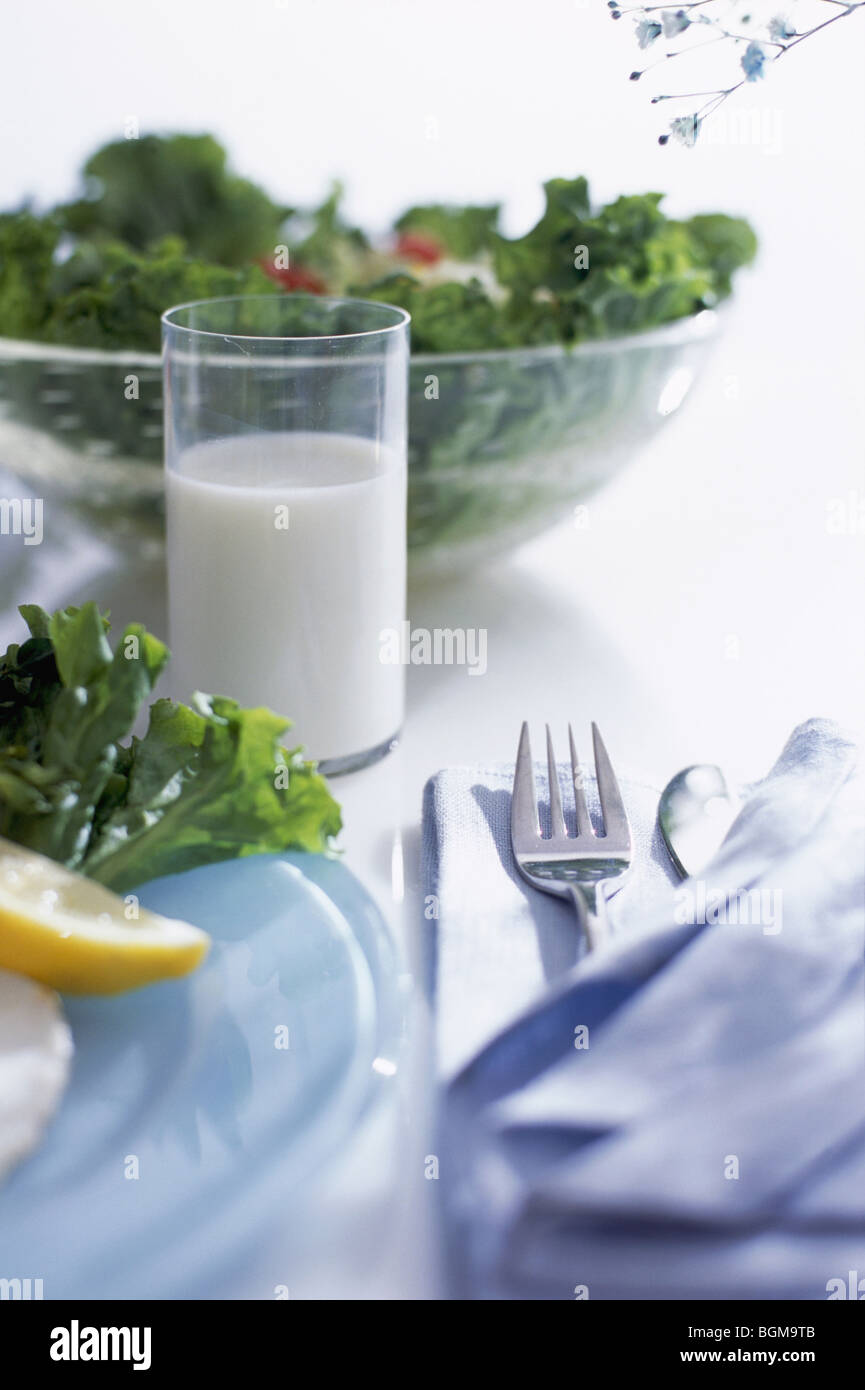 Ciotola di insalata e un bicchiere di latte Foto Stock