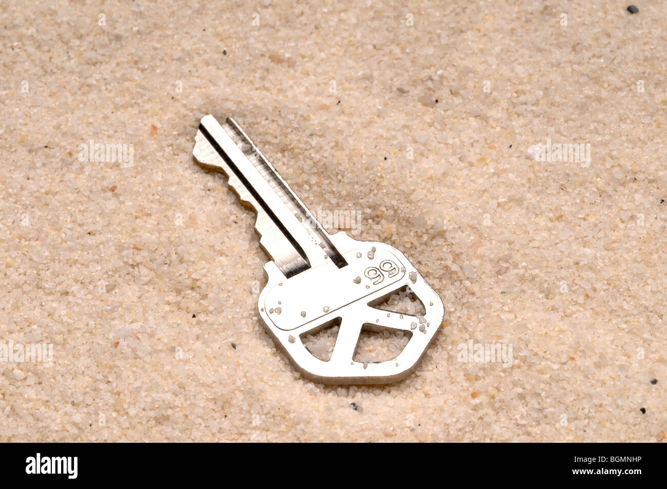 L'immagine orizzontale di una chiave di casa nella sabbia Foto Stock