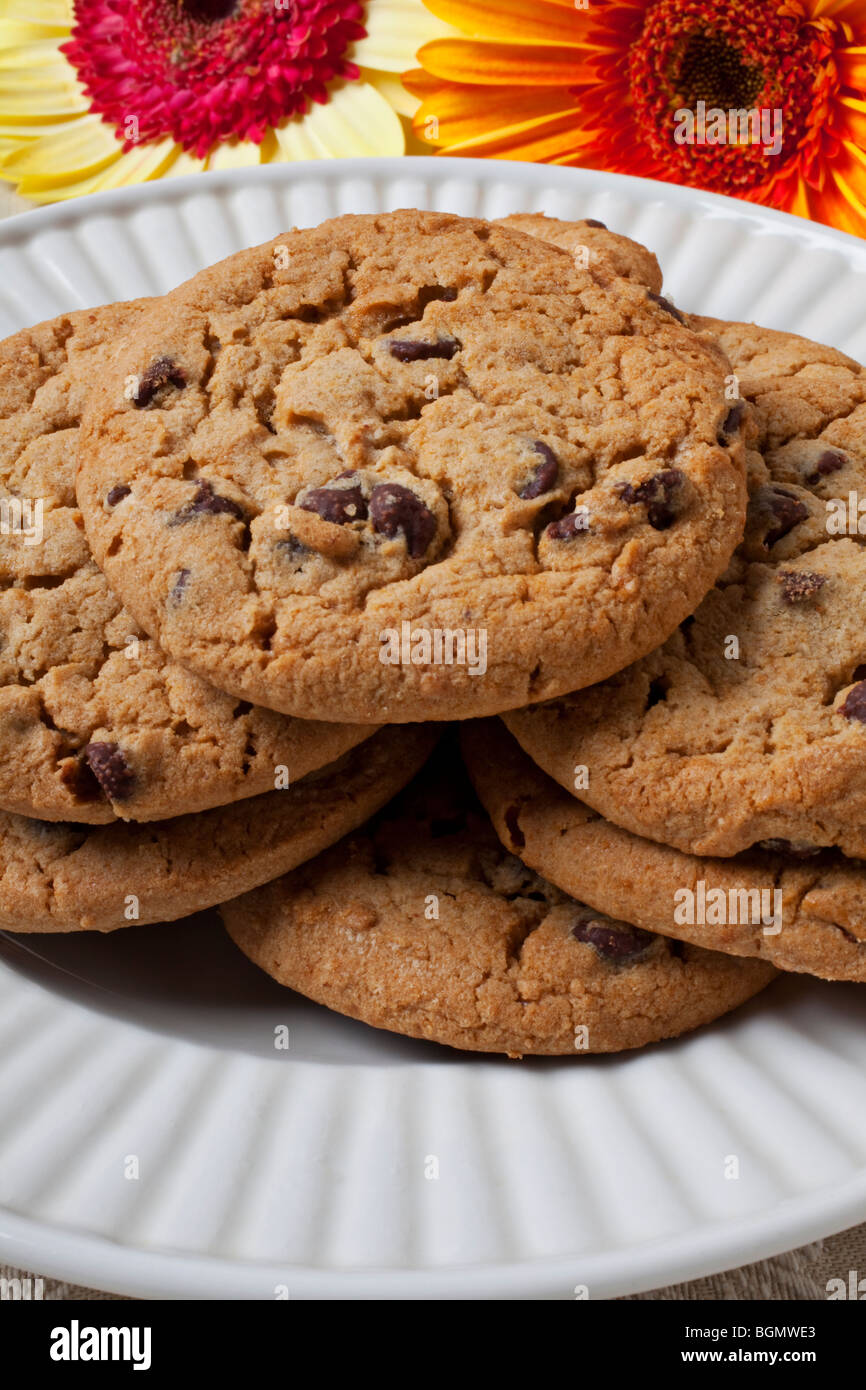I biscotti al cioccolato sulla piastra bianca con la margherita Foto Stock