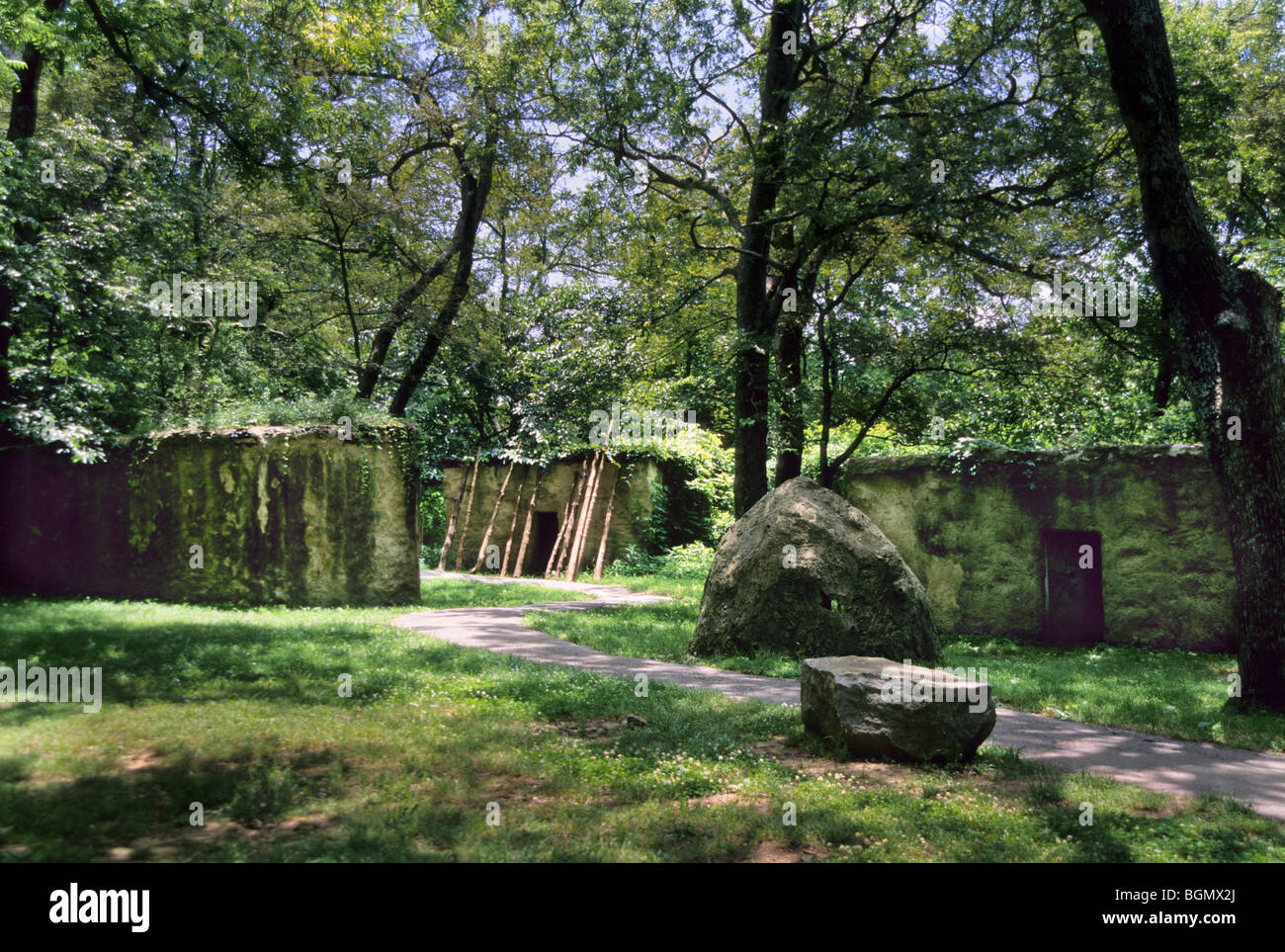 Grande Muro di pietra costruiti di bargiglio-e-daub cerchi un tradizionale indiani Cherokee borgo ricostruito in Tahlequah OK. Foto Stock