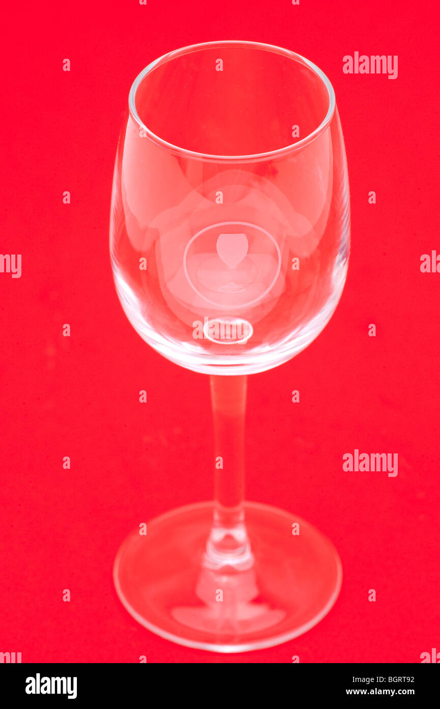 Bicchiere di vino su uno sfondo rosso Foto Stock