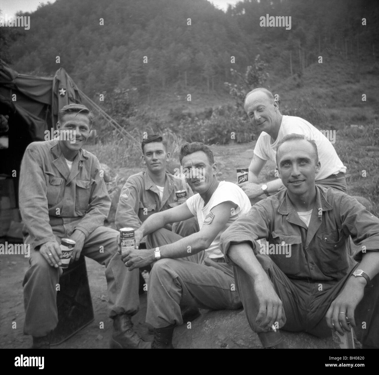 Ufficiali della seconda divisione di fanteria rilassarsi per una foto di gruppo mentre si beve la loro razione di birra in una pausa dalla guerra coreana. Foto Stock