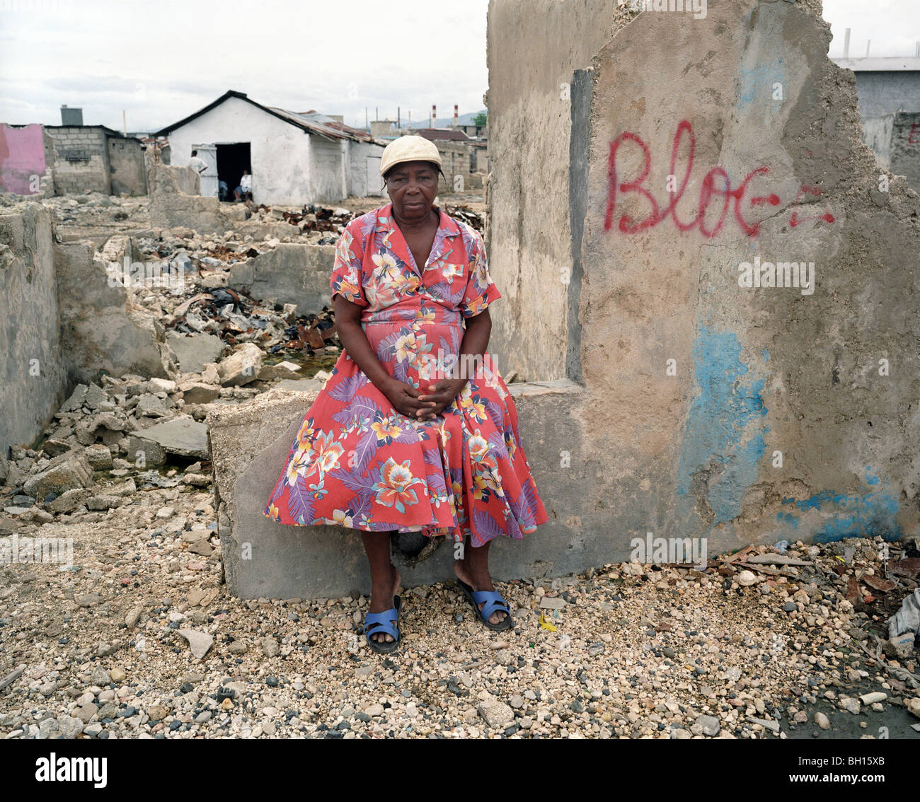 Baraccopoli della città "Soleil", Haiti. Questa donna appoggia(pone) davanti alle rovine della sua casa distrutta dalle bande criminali. Foto Stock