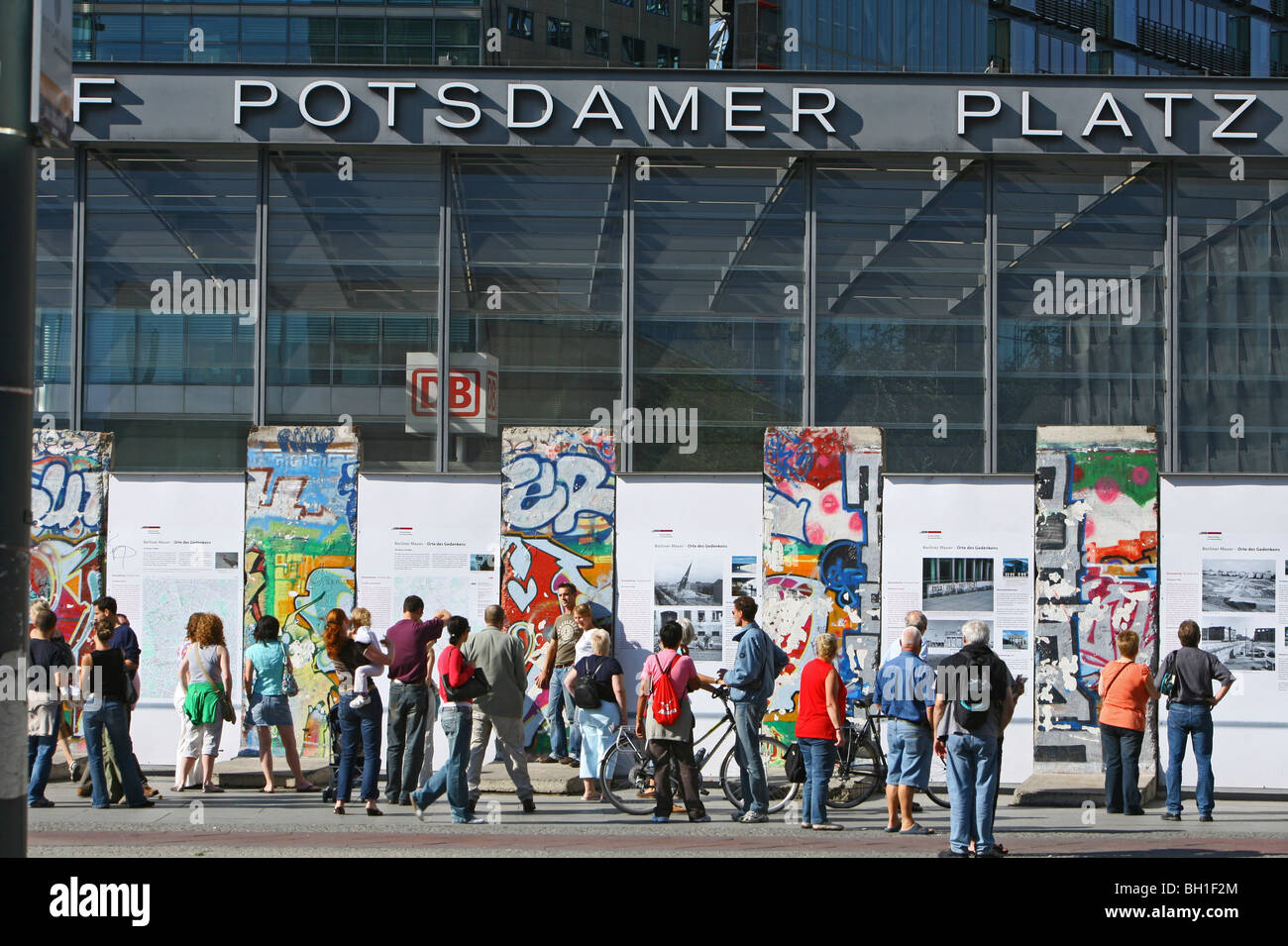 Persone che guardano i resti del muro di Berlino presso la piazza Potsdamer Platz di Berlino, Germania, Europa Foto Stock