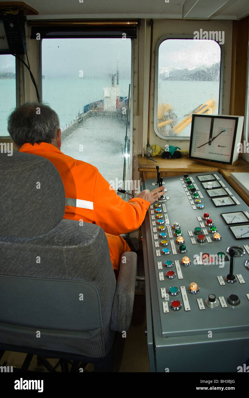 Operatore al lavoro su una draga in controllo della testa di trascinamento attraverso il quale il fango viene aspirato dal fondo del porto. Foto Stock