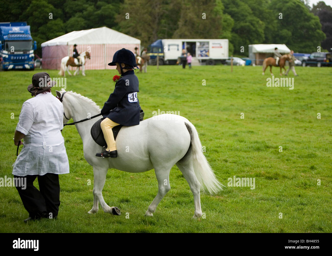 Madre e figlia e pony bianco a horse show in Norfolk. Foto Stock