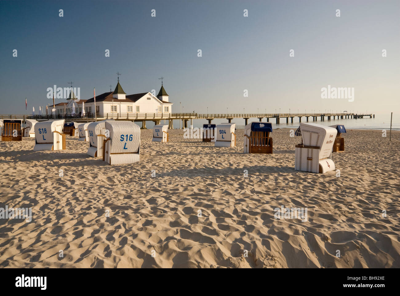 Sedie da spiaggia in vimini e Seebrücke pier in Ahlbeck sull isola di Usedom nel Meclemburgo-Pomerania Occidentale, Germania Foto Stock